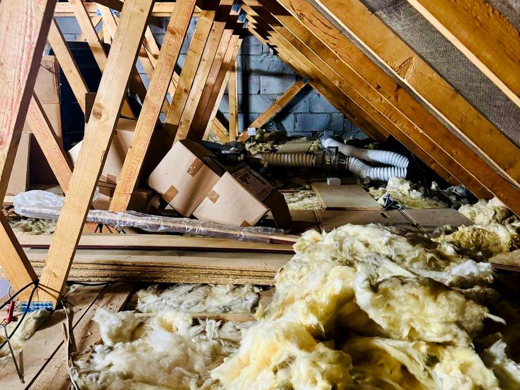 Before: loose mineral wool insulation and no floor between the joists