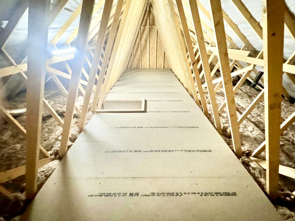 An LED strip light illuminating a boarded loft